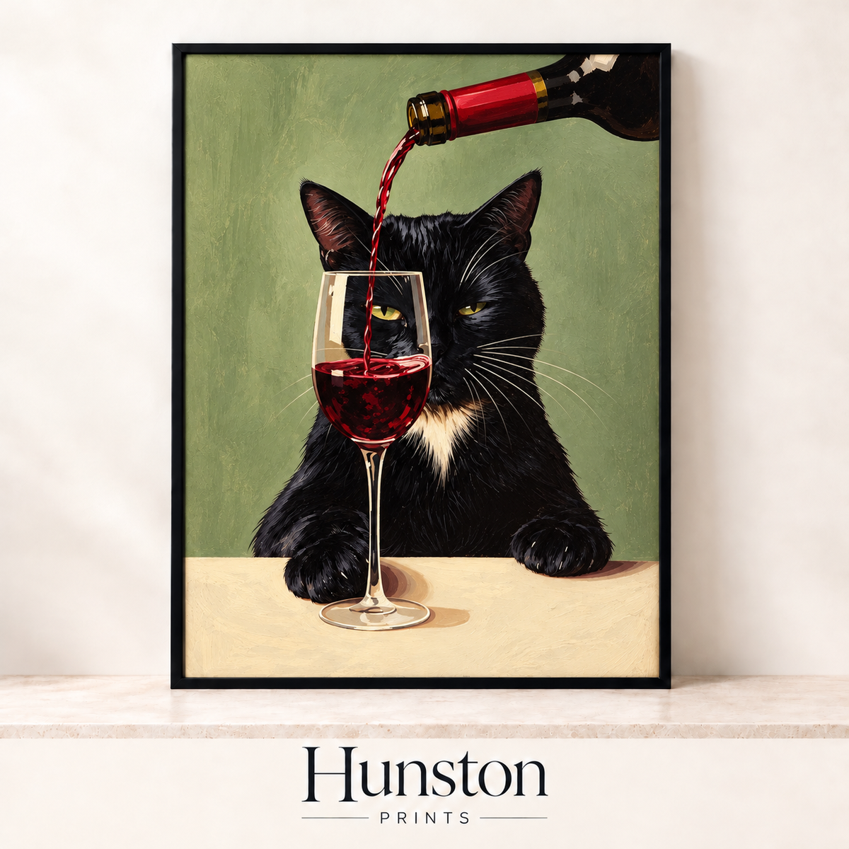 Black tuxedo cat behind a glass of red wine being poured on sage green