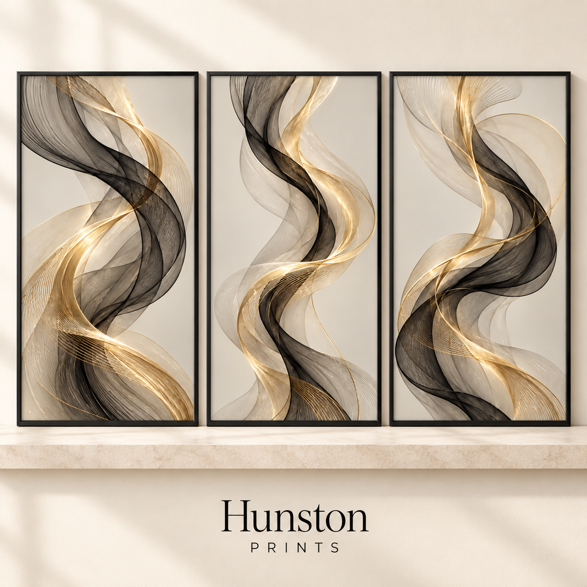 Set of three black and gold flowing abstract ribbon prints on cream