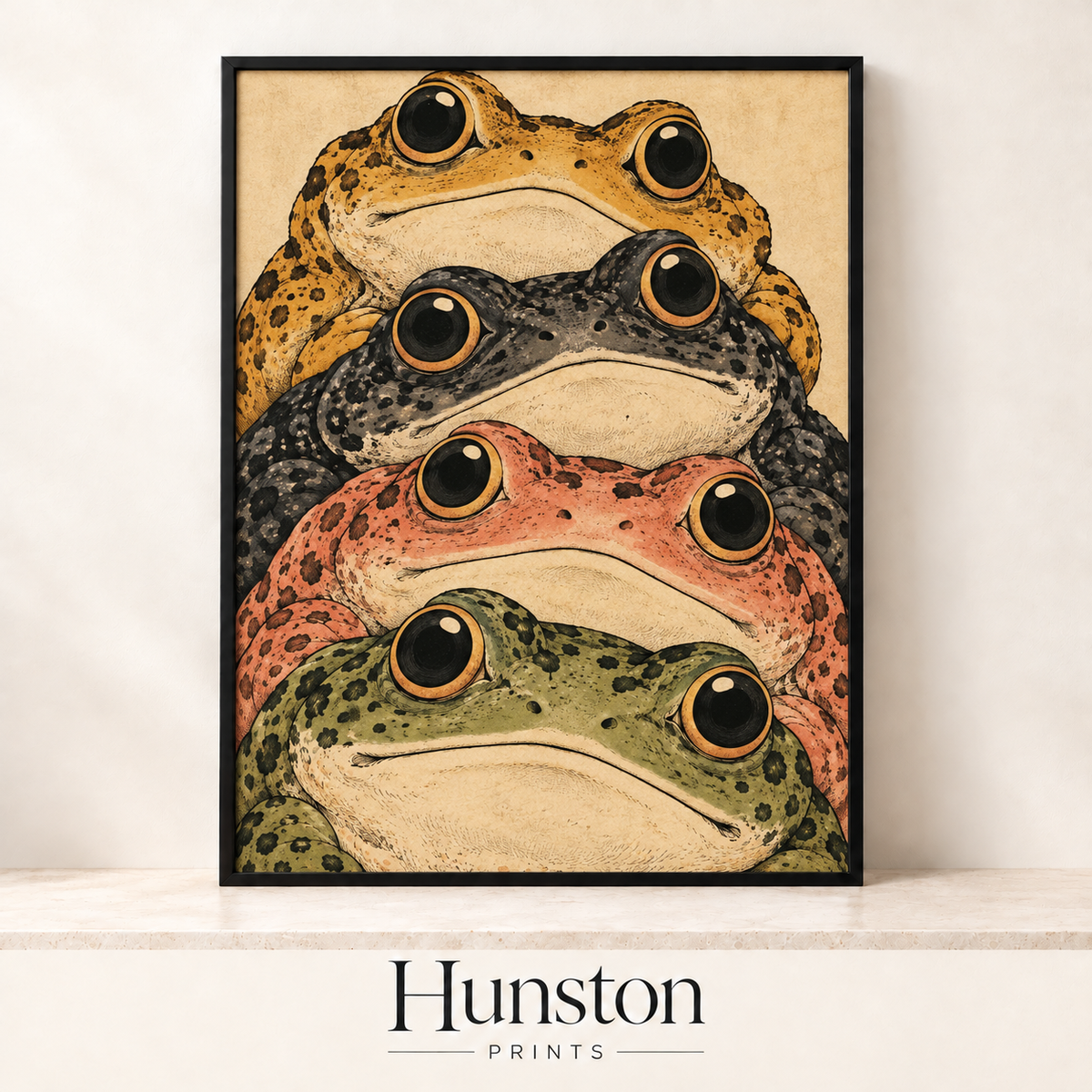 Four wide-eyed toads in mustard, grey, coral and green stacked on top of each other