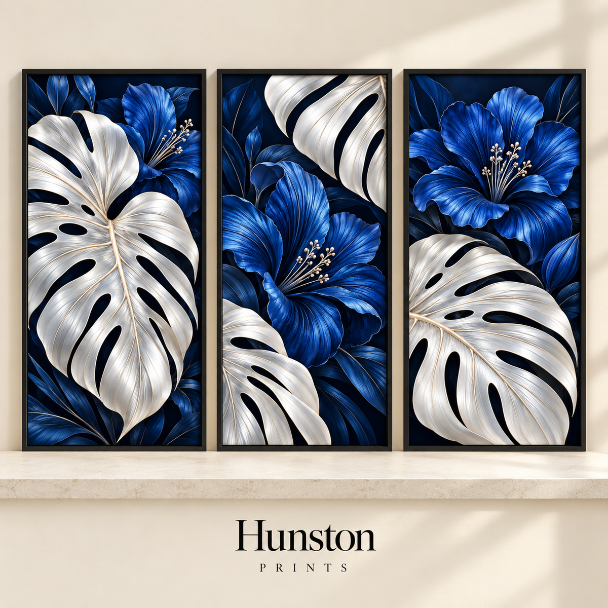 Set of three prints with silver monstera leaves and blue flowers on navy