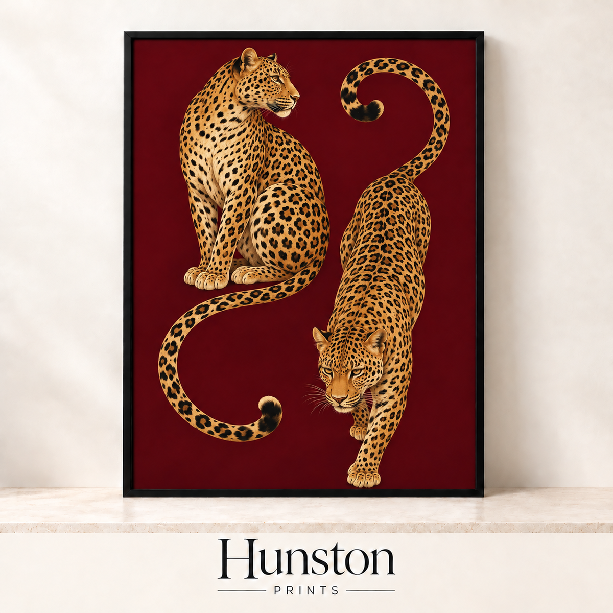 Two leopards with curling tails on a deep burgundy background