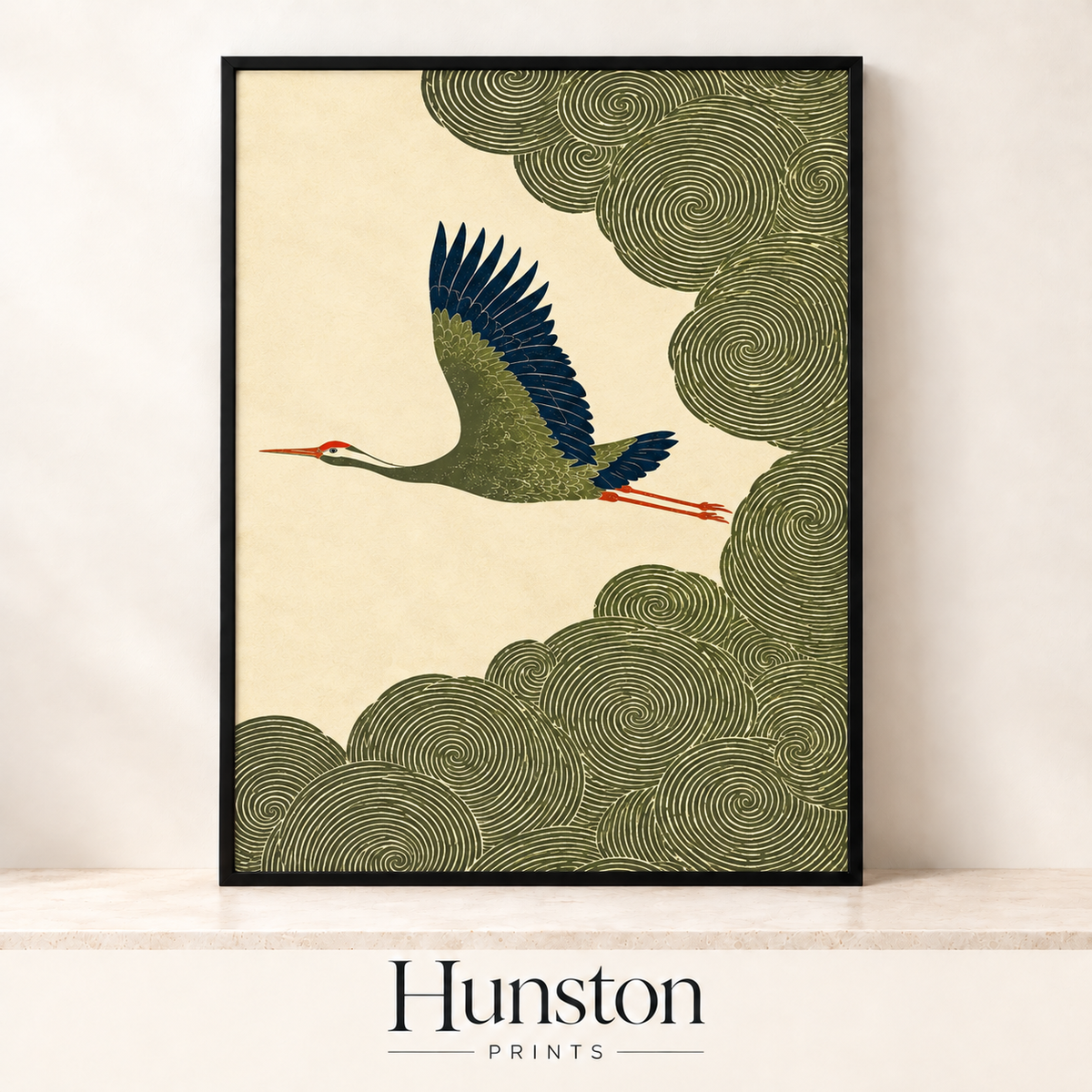 Crane with navy wings flying past swirling olive green clouds on cream background