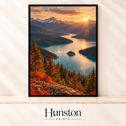 Sunset over snowy mountains and a winding turquoise lake with red autumn foliage and pines