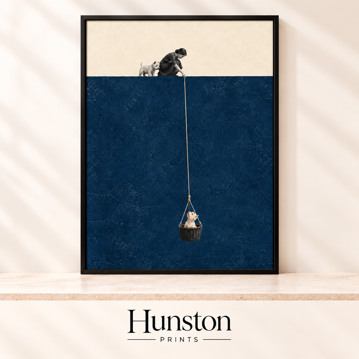 Woman with a terrier lowering another small dog in a basket on a rope over a navy background