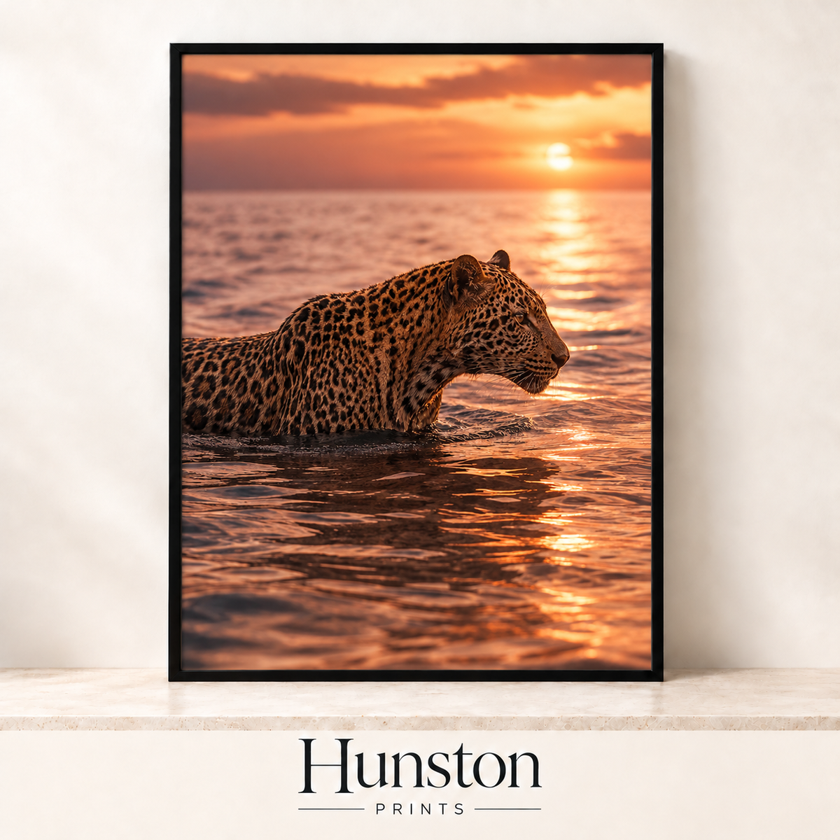 Leopard wading through the sea at sunset