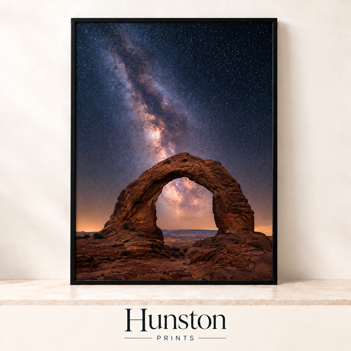 Milky Way over a red sandstone arch in the desert at night