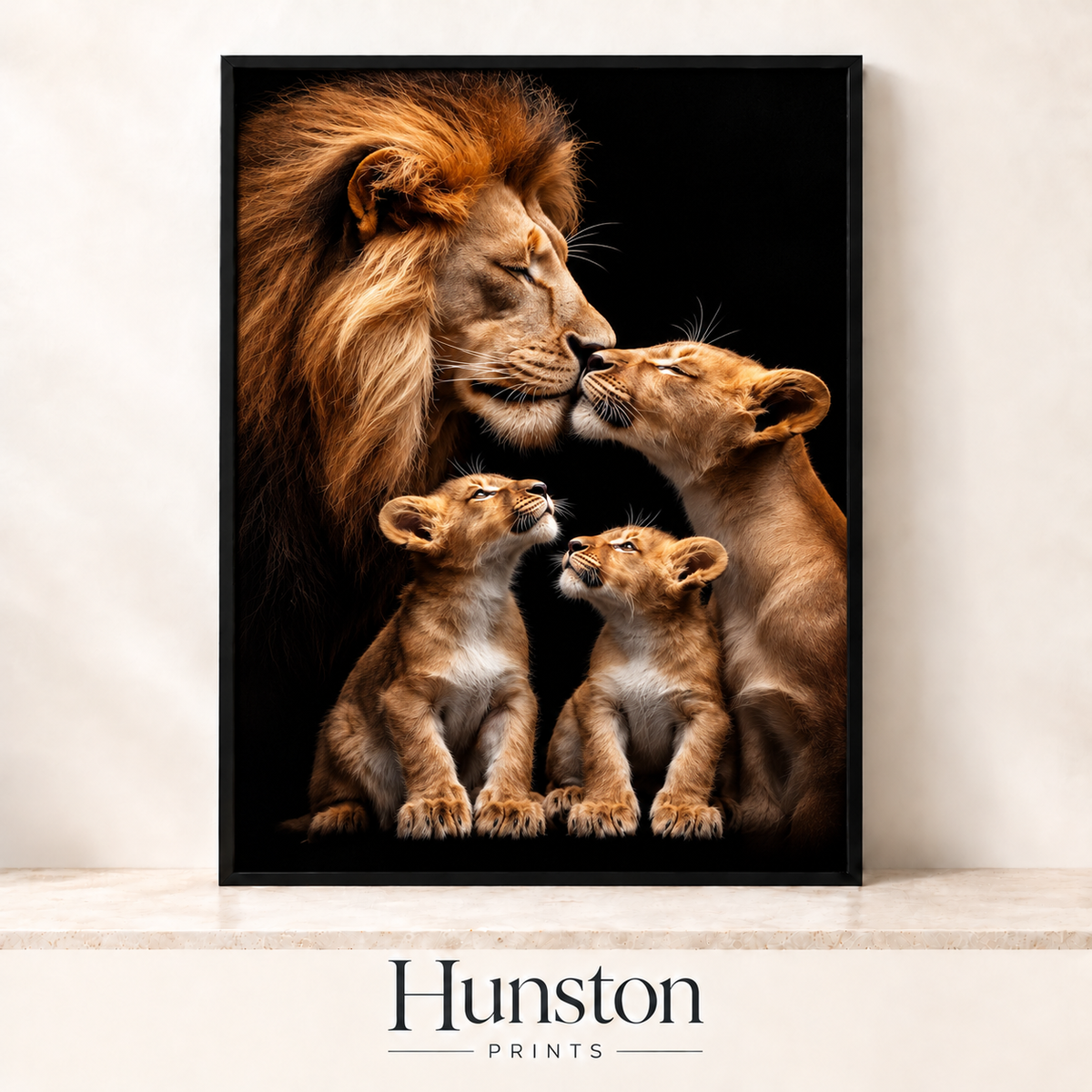 Lion and lioness nuzzling with two cubs looking up at them