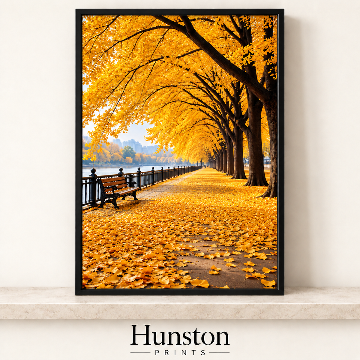 Avenue of golden autumn trees over a leaf-covered riverside path with a bench