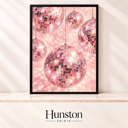 Pink glittering disco balls hanging against a sparkling blush pink background