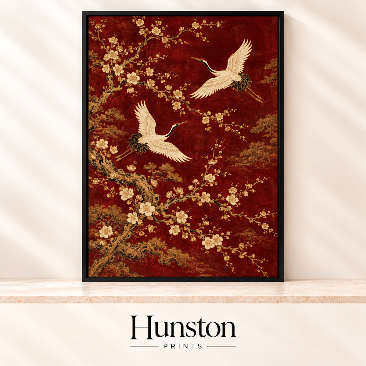 Two white cranes flying among gold plum blossom on a deep red background