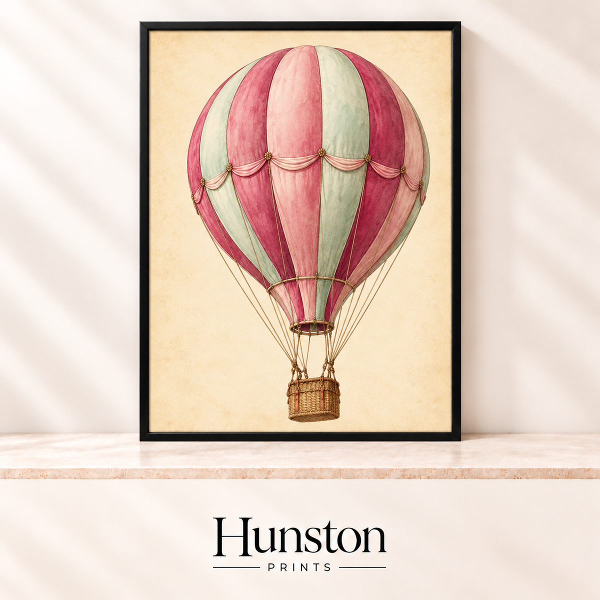 Vintage pink and mint striped hot air balloon with wicker basket on a cream parchment background