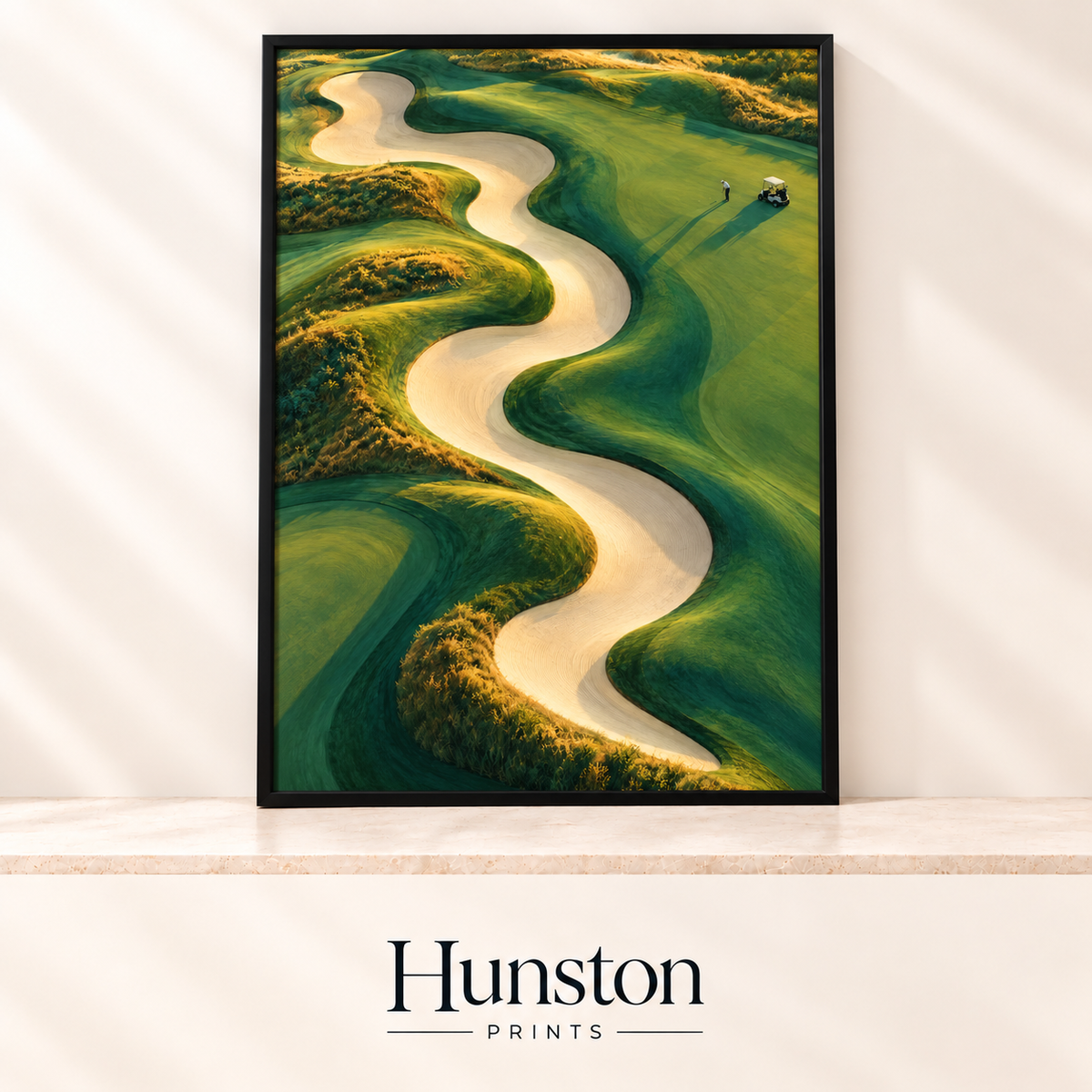 Aerial view of a long winding sand bunker through green golf fairways with a golfer and buggy